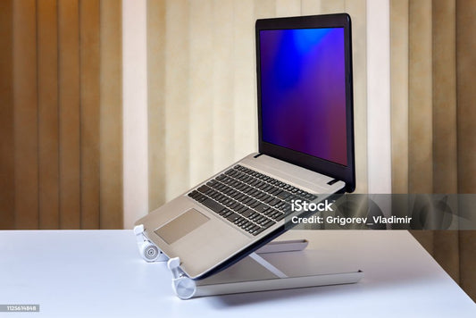 Laptop placed on an adjustable ergonomic laptop stand for desk, showcasing the laptop holder’s design to improve posture and reduce strain